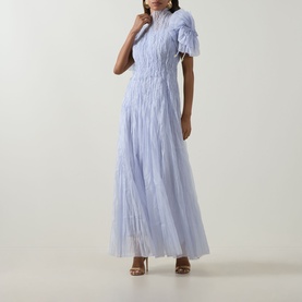 Model wearing Aje Clara Pintuck Dress in French Blue, maxi length with pintuck detail, puff sleeves and high neckline, styled with tan heeled sandals