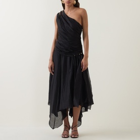 Model wearing black one-shoulder midi dress with ruched bodice, draped asymmetric hem, styled with strappy heeled sandals