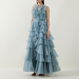 Model wearing Aje Cleo Ruffle Gown in Duck Egg, sleeveless tiered ruffle maxi dress with pleated bodice and V-neckline detail