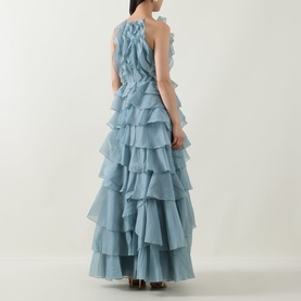 Model wearing Aje Cleo Ruffle Gown in duck egg, showing tiered ruffle skirt, sleeveless back and smocked side detailing.