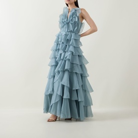 Model wearing Aje Cleo Ruffle Gown in Duck Egg, sleeveless tiered ruffle maxi dress with pleated bodice and metal neckline detail.