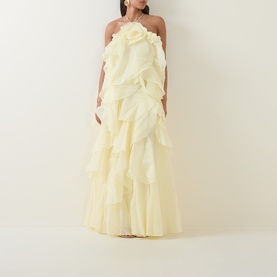 Model wearing Aje Pandorea Ruffle Dress in butter, halter neck, layered ruffles, maxi length voluminous silhouette