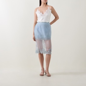 Model wearing Aje Ophelia Lace-Trim Layered Skirt in Duck Egg, semi-sheer overlay with lace hem, styled with white lace cami and strappy sandals