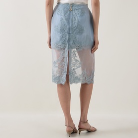 Model wearing Aje Ophelia Lace-Trim Layered Skirt in Duck Egg, semi-sheer overlay with lace detailing, styled with nude heeled sandals.