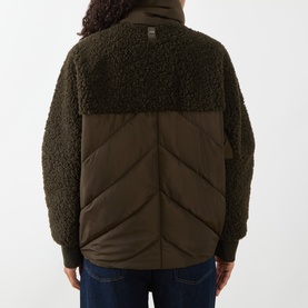 Model wearing HIGH olive coat, rear view, featuring teddy fleece upper and quilted padded lower body with zip detail