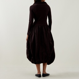 Model wearing HIGH brown dress with fitted long-sleeve top, voluminous gathered skirt and balloon hem, back view.
