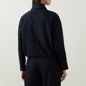 Model wearing HIGH navy jacket, rear view, relaxed fit with elasticated hem, styled with matching navy trousers