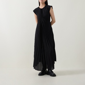 Model wearing HIGH black pleated midi dress with cap sleeves and button-front detail, styled with black chunky loafers