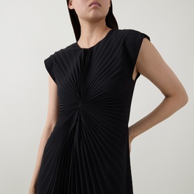 Model wearing HIGH black pleated dress with sunburst gathering detail at centre, cap sleeves, and relaxed silhouette in 100% polyester