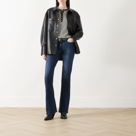 Model wearing Rag & Bone bootcut jeans in lulu dark denim, styled with black leather overshirt, striped top and black heeled loafers.