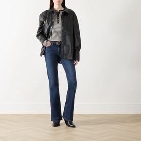 Model wearing Rag & Bone bootcut jeans in lulu denim, styled with a black leather jacket and striped top, with black ankle boots.