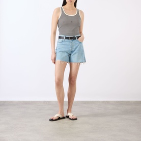 Model wearing Rag & Bone denim shorts in light blue wash with raw hem, styled with grey tank top and black belt.