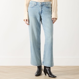 Model wearing Rag & Bone straight-leg jeans in light blue denim, styled with black ankle boots and a cream knit top.