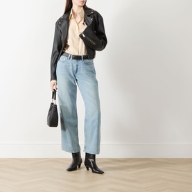 Model wearing Rag & Bone straight jeans in light wash denim, styled with black leather jacket, beige shirt, and black heeled boots.