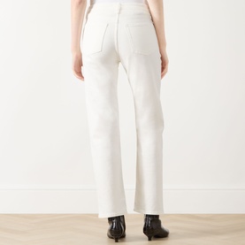 Model wearing Rag & Bone Miramar Harlow Ankle Straight-Leg Jeans in white, back view, paired with black heeled boots.