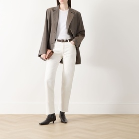 Model wearing Rag & Bone Miramar Harlow Ankle Straight-Leg Jeans in white, styled with brown blazer, white tee, brown belt and black heeled boots.