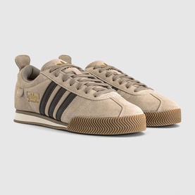 Adidas trainers in crystal linen and dark brown suede, black three-stripe detail, gold branding, gum rubber sole, lace-up fastening