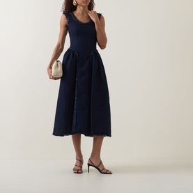 Model wearing Self-Portrait Boucl&eacute; Flared Dress in navy, sleeveless midi with scoop neckline and frayed trims, styled with strappy heels and cream