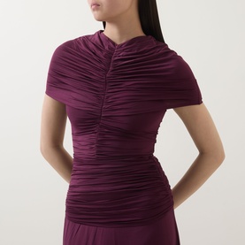 Model wearing Self-Portrait burgundy ruched midi dress with short sleeves and high neck, styled close to body.