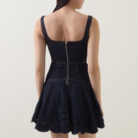 Model wearing Self-Portrait blue cotton mini dress, rear view showing square neckline, zip back, broderie anglaise hem detail and flared skirt