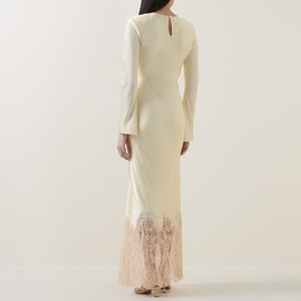 Model wearing Self-Portrait yellow maxi dress with long sleeves, rear keyhole neckline, and contrast lace hem detail.