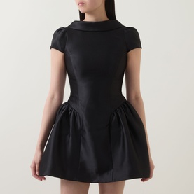 Model wearing Self-Portrait black structured mini dress with fold collar, cap sleeves, fitted bodice and voluminous tulip skirt