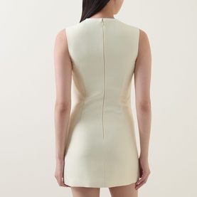 Model wearing Self-Portrait yellow sleeveless mini dress, rear view, structured silhouette with centre back seam detail