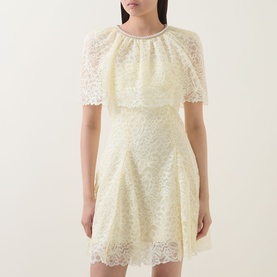 Model wearing Self-Portrait yellow lace mini dress with flutter cape overlay, jewel neckline trim and short sleeves, A-line silhouette