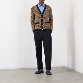 Model wearing Valentino camel wool cardigan with VLogo jacquard pattern, navy trim, styled with dark trousers and loafers