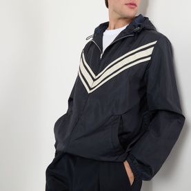 Model wearing Valentino dark marine casual jacket with beige chevron stripe detail, hood, and zip fastening