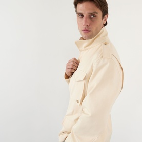 Model wearing Valentino sea shell cotton casual jacket, shown in close-up side profile with raised collar and chest pocket detail