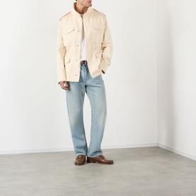 Model wearing Valentino Sea Shell cotton casual jacket with chest pockets, styled with light blue jeans and brown loafers.