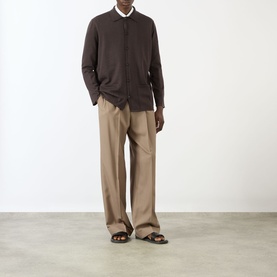 Model wearing Valentino Patch Pocket Knitted Polo Cardigan in brown, styled with taupe wide-leg trousers and dark sandals.