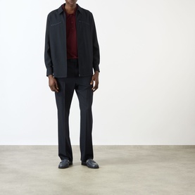 Model wearing Valentino Chest Pocket Zip Overshirt in storm blue wool, styled with dark trousers and a burgundy top.