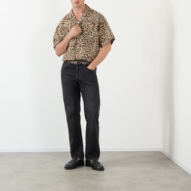 Model wearing Valentino Multicolor Animalier silk casual shirt with black straight-leg jeans and black leather loafers
