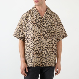 Model wearing Valentino Multicolor Animalier silk casual shirt with leopard print, short sleeves and open camp collar, styled with black trousers