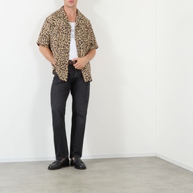 Model wearing Valentino Multicolor Animalier silk casual shirt with black jeans and black loafers