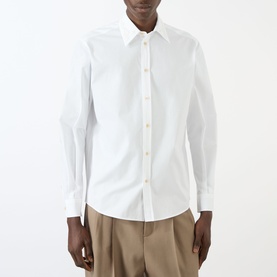 Model wearing Valentino Tonal Embroidered White Shirt with point collar, long sleeves, and front button fastening, styled with beige trousers.
