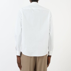 Model wearing Valentino Tonal Embroidered Shirt in white, back view, long sleeves with buttoned cuffs, styled with taupe trousers.