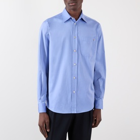 Model wearing Valentino cloudless sky blue cotton casual shirt with chest pocket and button-front placket, styled with dark trousers
