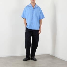 Model wearing Valentino Camica Maniche Bowling Casual Shirt in Celeste Denim, short sleeves, spread collar, styled with dark trousers and black