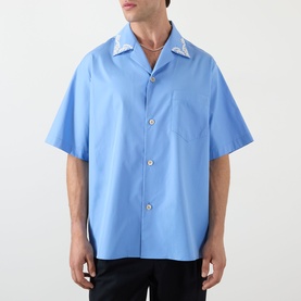 Model wearing Valentino Camica Maniche Bowling Casual Shirt in celeste denim with printed collar detail and short sleeves