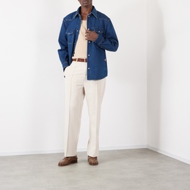Model wearing Valentino medium blue denim casual shirt with cream trousers, brown belt and brown loafers.