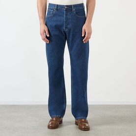 Model wearing Valentino medium blue denim jeans, straight-leg fit, styled with brown leather loafers