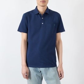 Model wearing Valentino indigo cotton polo shirt with chest pocket and short sleeves, styled with light blue jeans