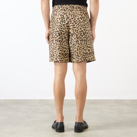 Model wearing Valentino multicolor animalier silk shorts, rear view, styled with black loafers