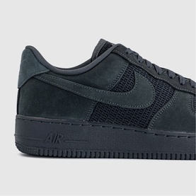 Nike Air Force 1 low-top trainer in anthracite, featuring suede and mesh panels with tonal Swoosh and Air unit on dark rubber sole.