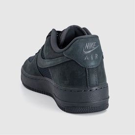 Nike Air Force 1 low-top trainer in anthracite suede with tonal swoosh, AIR heel tab, and black rubber sole, rear angle view.