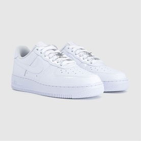 Nike Air Force 1 trainers in white patent leather with white rubber sole and tonal Swoosh logo, pair angled view