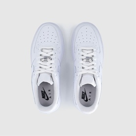 Nike Air Force 1 trainers in white patent leather, overhead flat-lay view showing both shoes with white laces and silver Air branding tabs